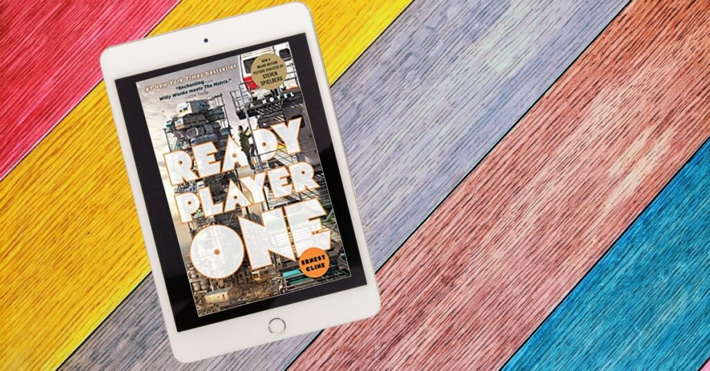 Multicolored wood planks in background with eReader displaying Ready Player One