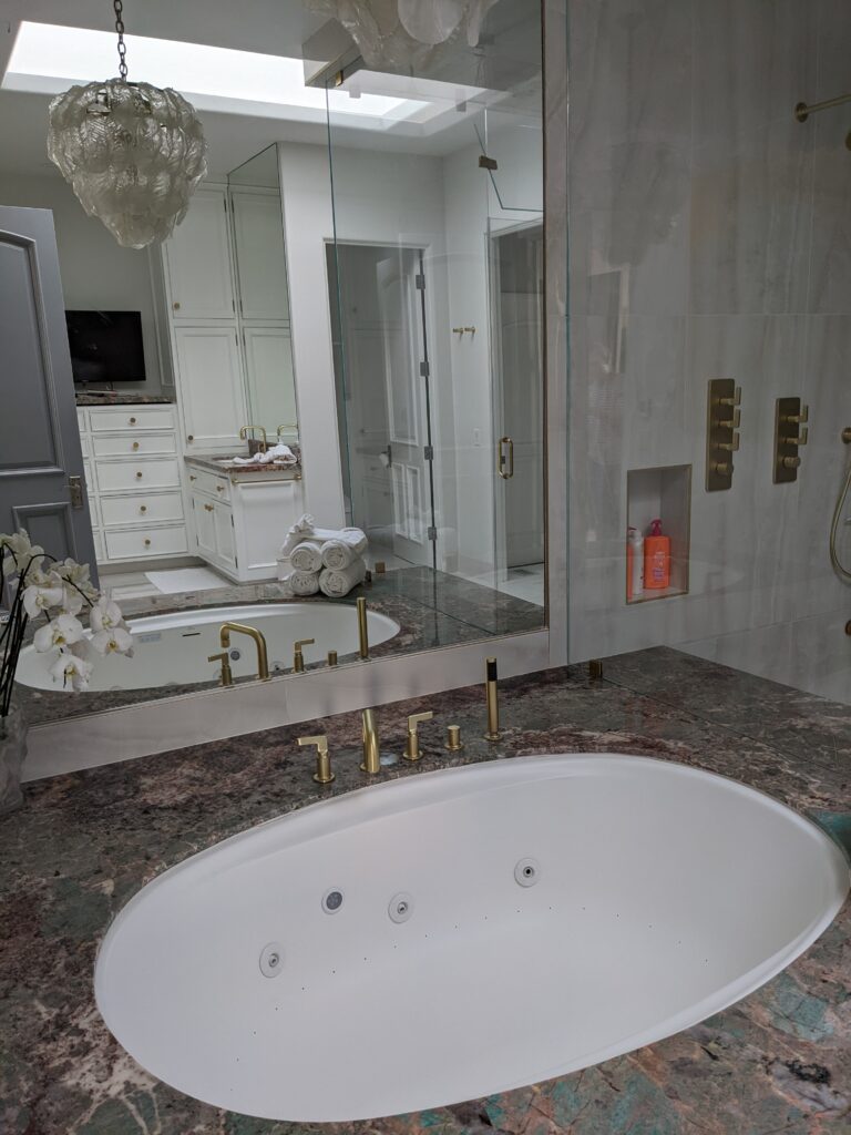 Malibu bathroom including a soaking tub and chandelier